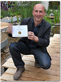 Professor Nigel Dunnett shows off the gold medal for the RBC Blue Water Roof Garden, co-sponsored by the RBC Blue Water Project, RBC Wealth Management and RBC Capital Markets.