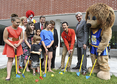 2013 World Figure Skating Champion Patrick Chan (centre) practices his putting with some kids at the announcement of Ronald McDonald House Charities Canada as the official charity partner of the RBC Canadian Open (Left to right - RMHC Canada CEO Kathy Loblaw, Golf Canada CEO Scott Simmons, RMHC Toronto CEO Jane Marco, RBC Group Head Dave McKay)