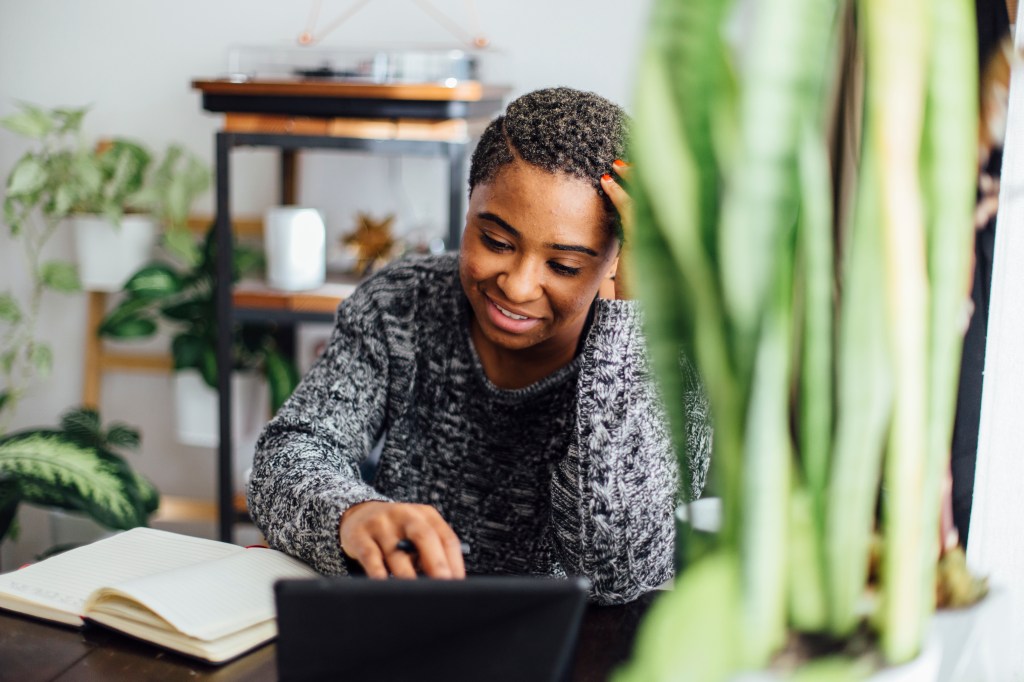 Young black woman on computer smiling