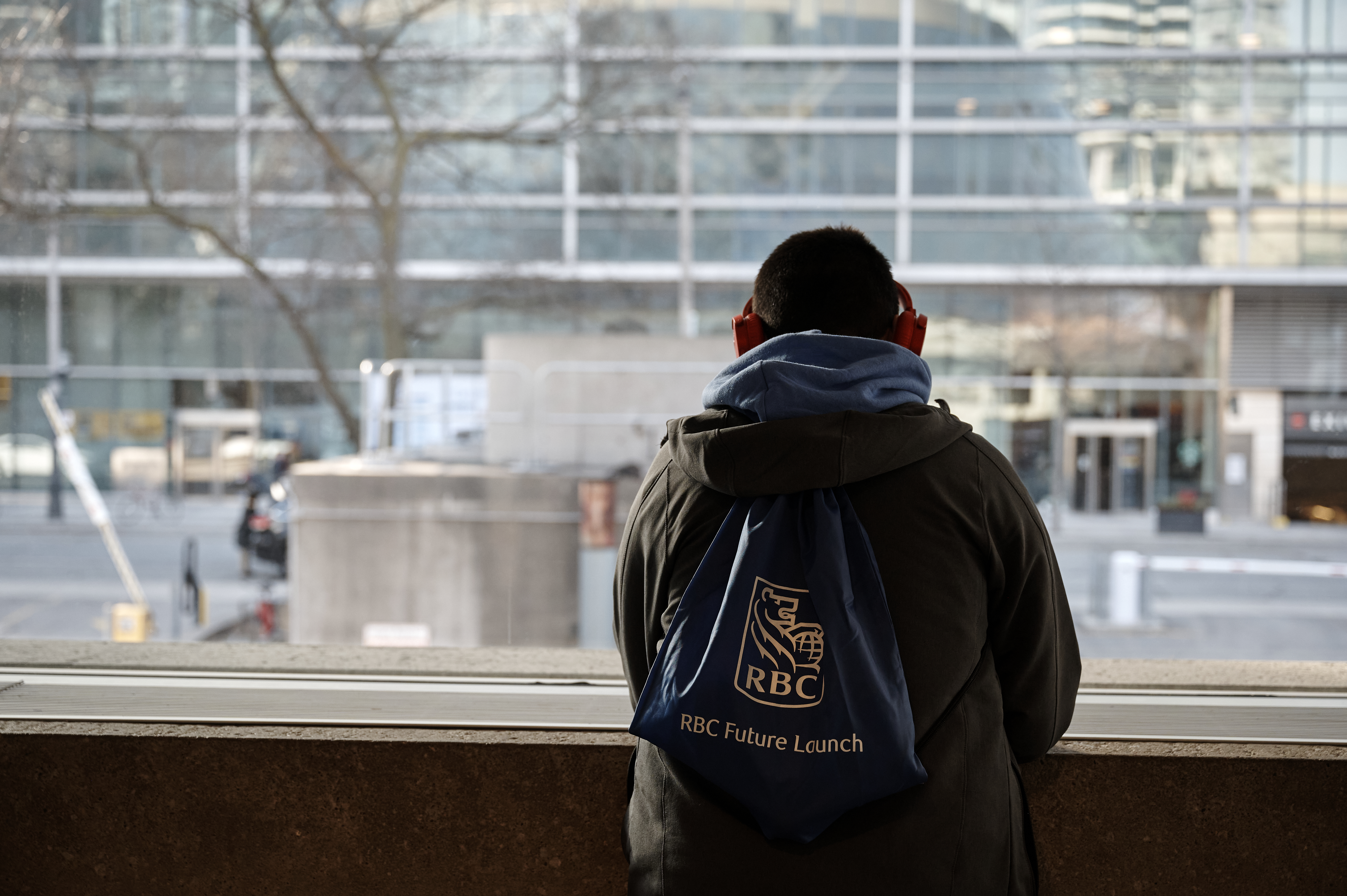 Young person looking outside the window