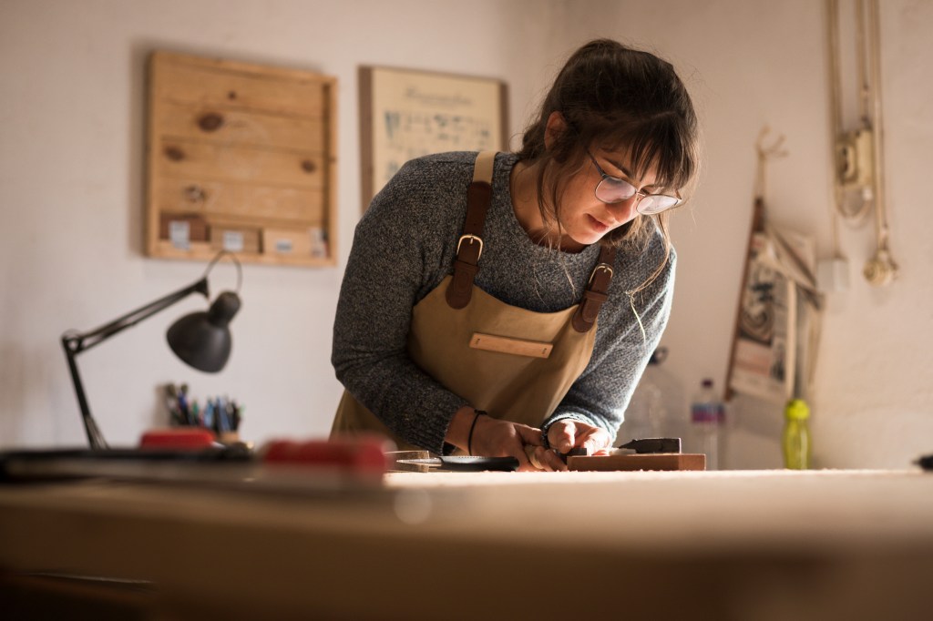 Young female carpenter working in a workshop