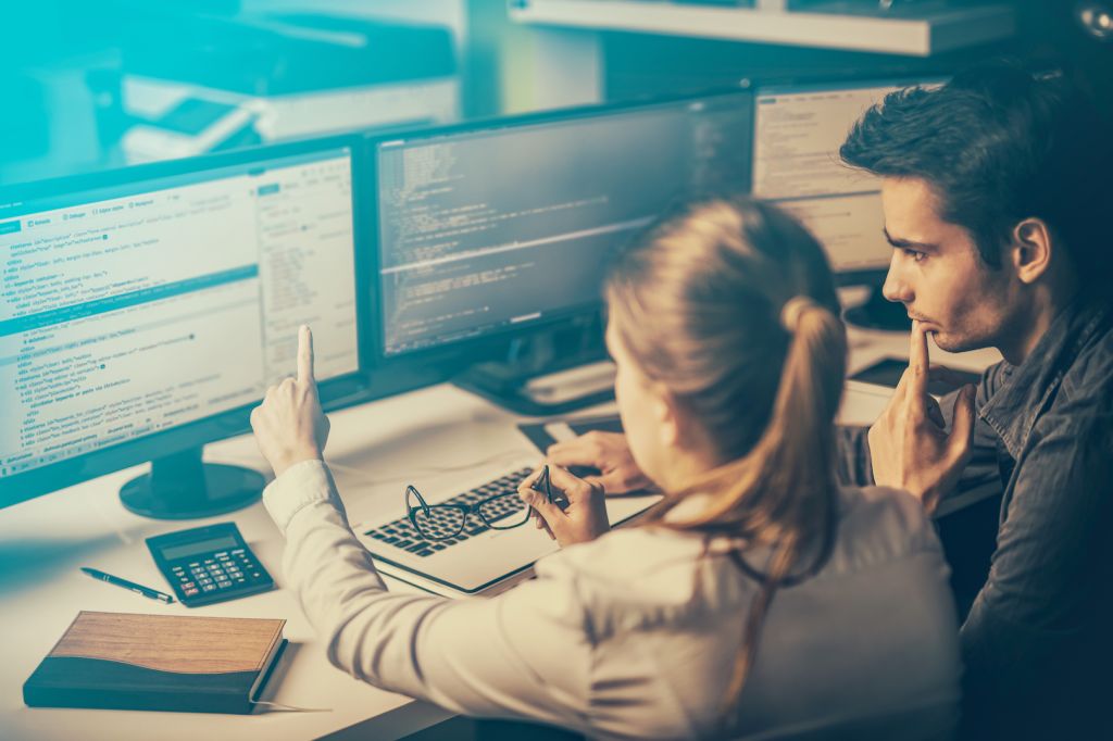 A man and a woman looking at a screen.