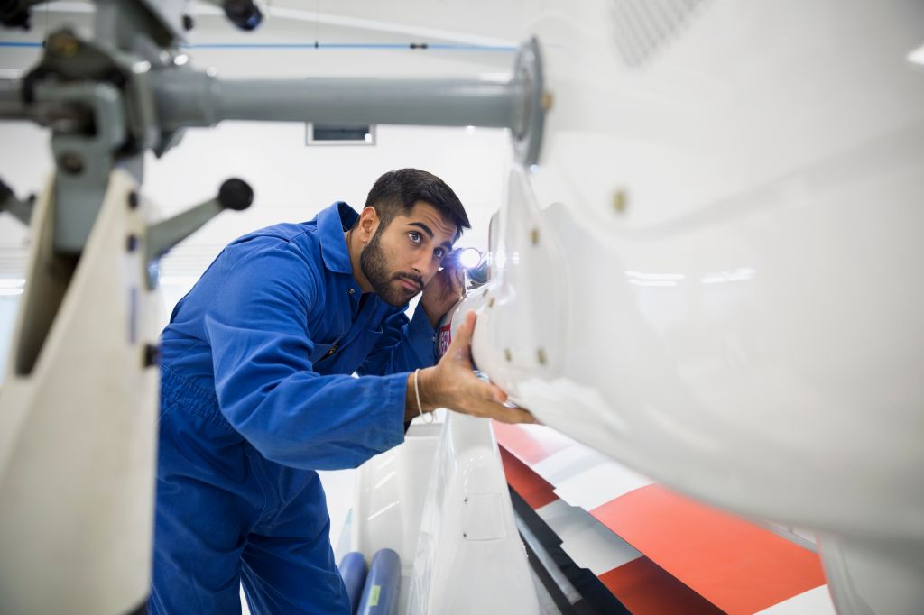 Helicopter mechanic examining panel